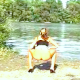 From the classic "Outdoor Pooping Paradise" sold by GP.Com - a girl squats on the ground beside a scenic lake and takes what seems to be a never-ending, rope of a shit!